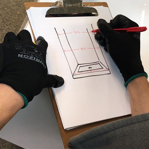 fleurco installer marking down the middle measurement on their drawing