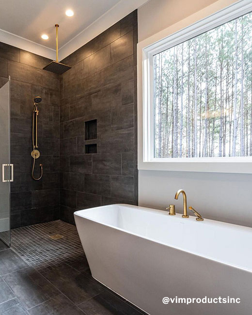 a rectangular shaped freestanding bathtub in an elegant and luxurious bathroom setup