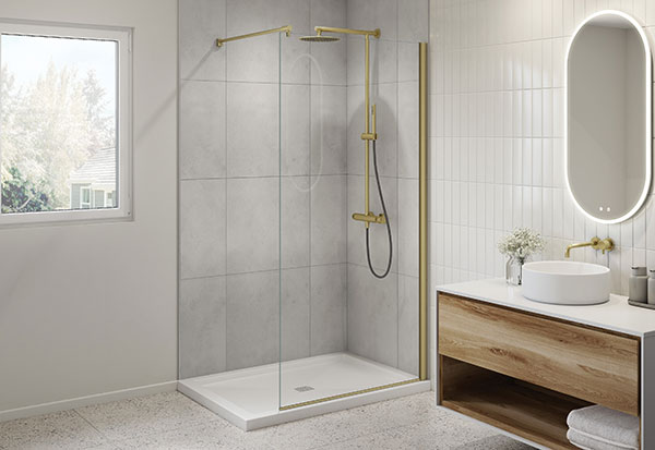 A white and light grey bathroom with brushed gold accents in the walk-in shower and fixtures