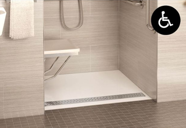 a zero-threshold acrylic shower base with linear drain for easy access to the shower area