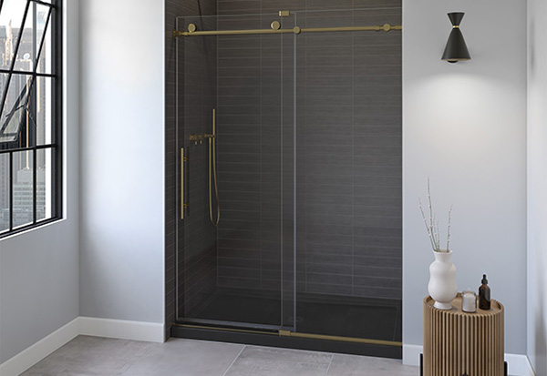 a glass shower door with brushed gold hardware and black brick-patterned shower wall in a bathroom featuring a balance between dark and light tones. 